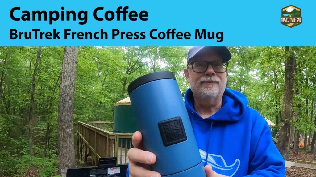 Erling holding a BruTrek French Press Coffee Mug while standing in front of a Yurt