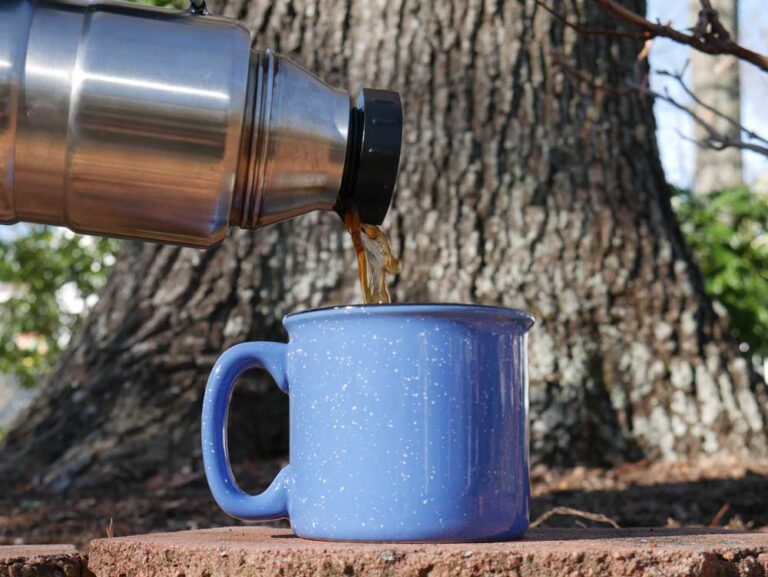 Pouring Coffee From Thermos Into Mug for Camping Coffee