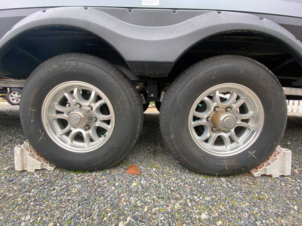Old faded chocks shown with travel trailer tires