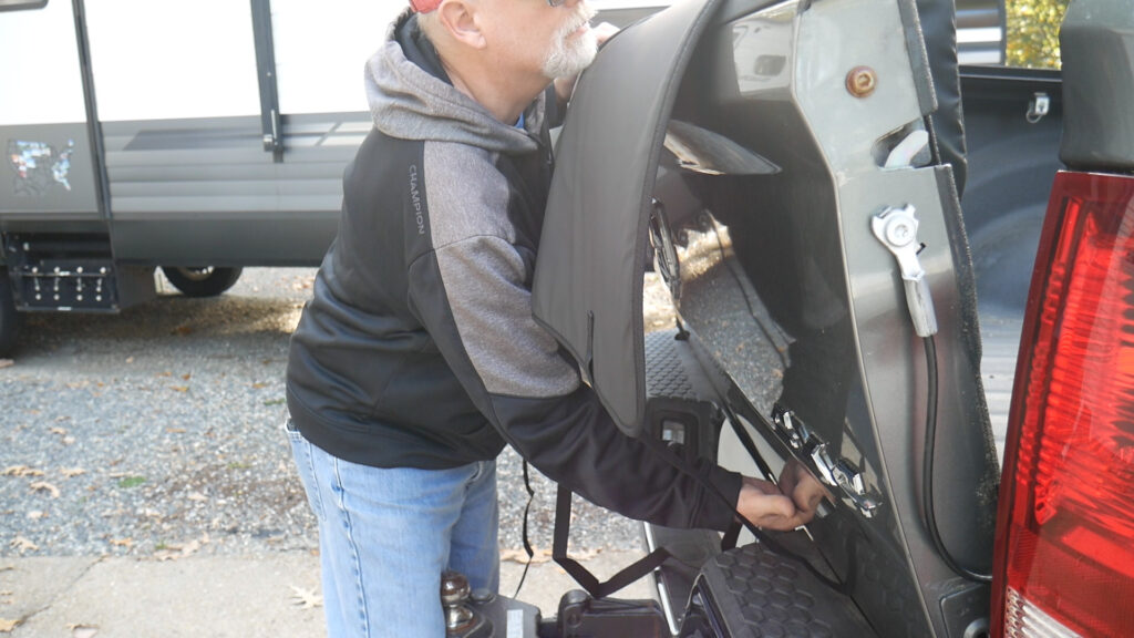 Feeding straps under tailgate to secure Roadmaster bike pad