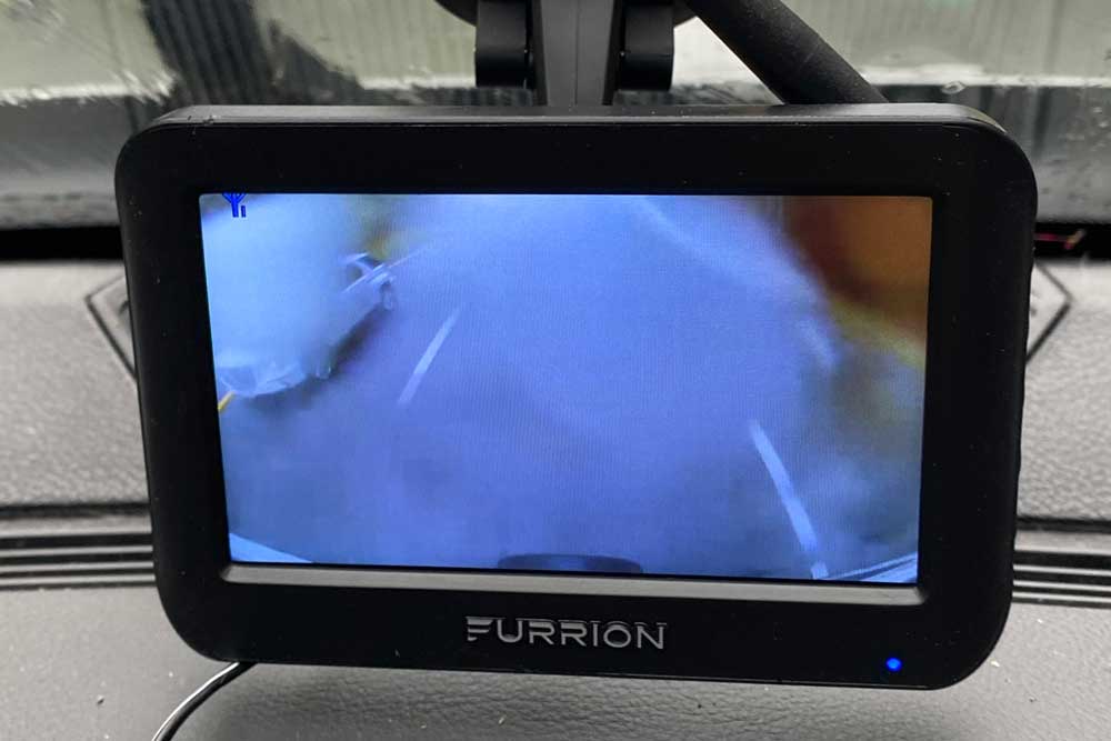 Furrion travel trailer backup camera showing view on a rainy day