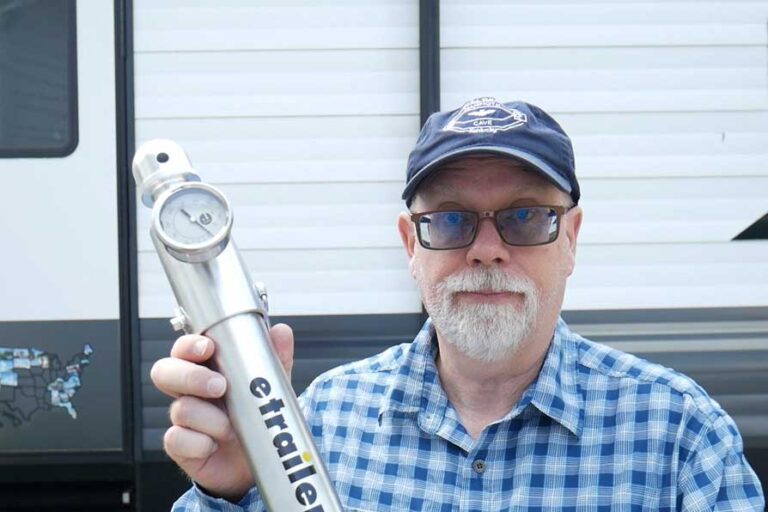 Erling holding an etrailer tongue weight scale