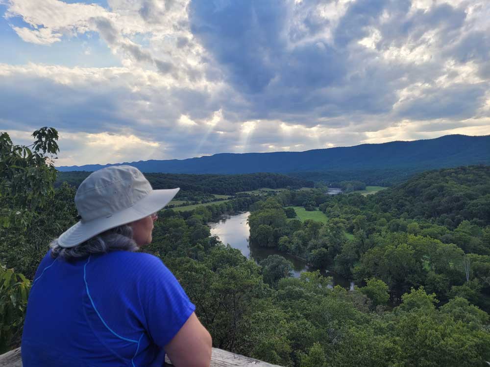 Woman enjoying a scenic overlook of the Shenandoah River and nearby mountains