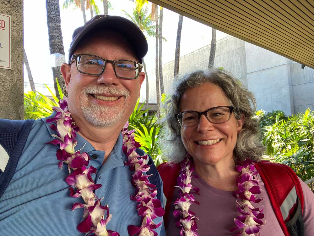 Erling and Judy wearing flower leis upon arriving in Hawaii