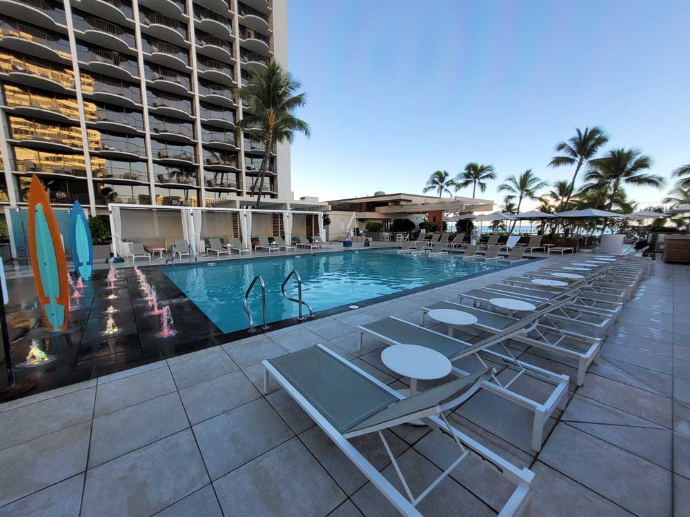 Swimming pool with lounge chairs at Waikiki Beach Mariott