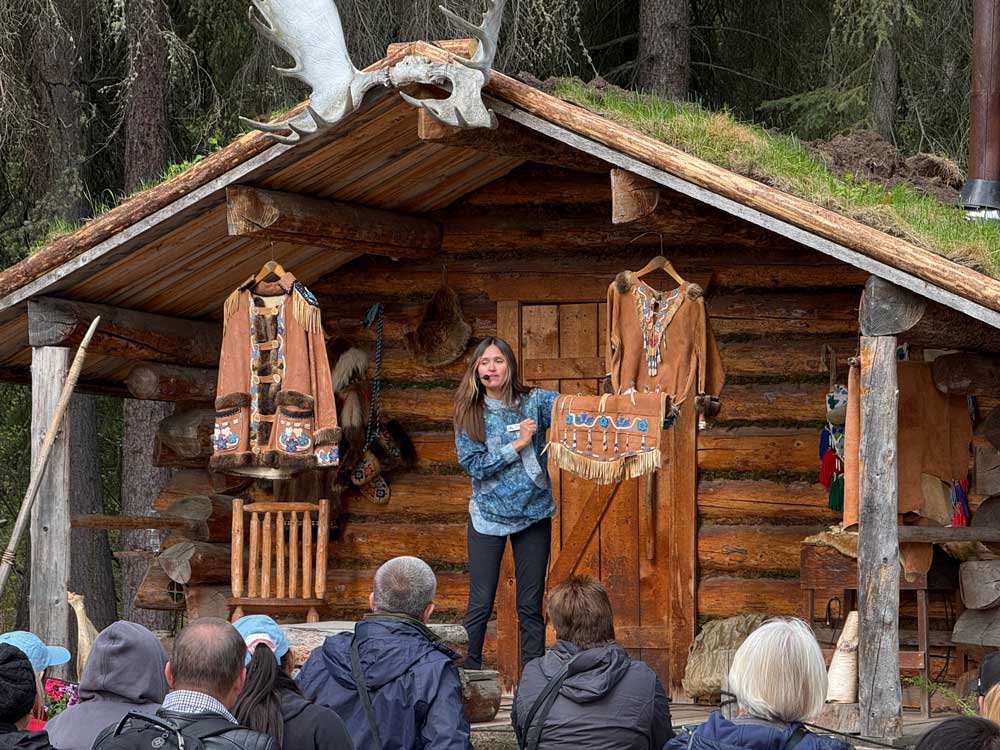 Person sharing information about Athabascan history and culture at Chena Village
