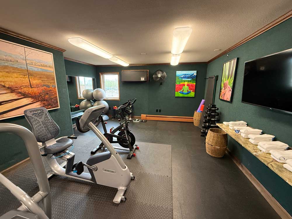 exercise room with cycles, weights, and towels at Pike's Waterfront Lodge Fairbanks Alaska
