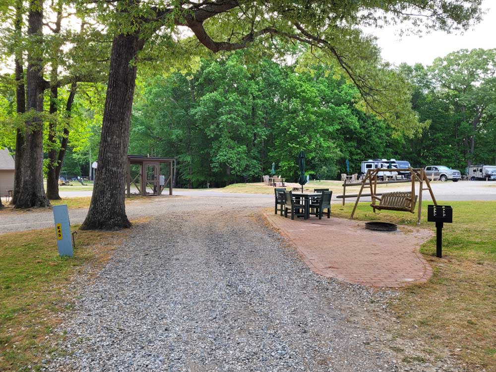 Campsite with patio and swing chair at Jellystone Park Williamsburg