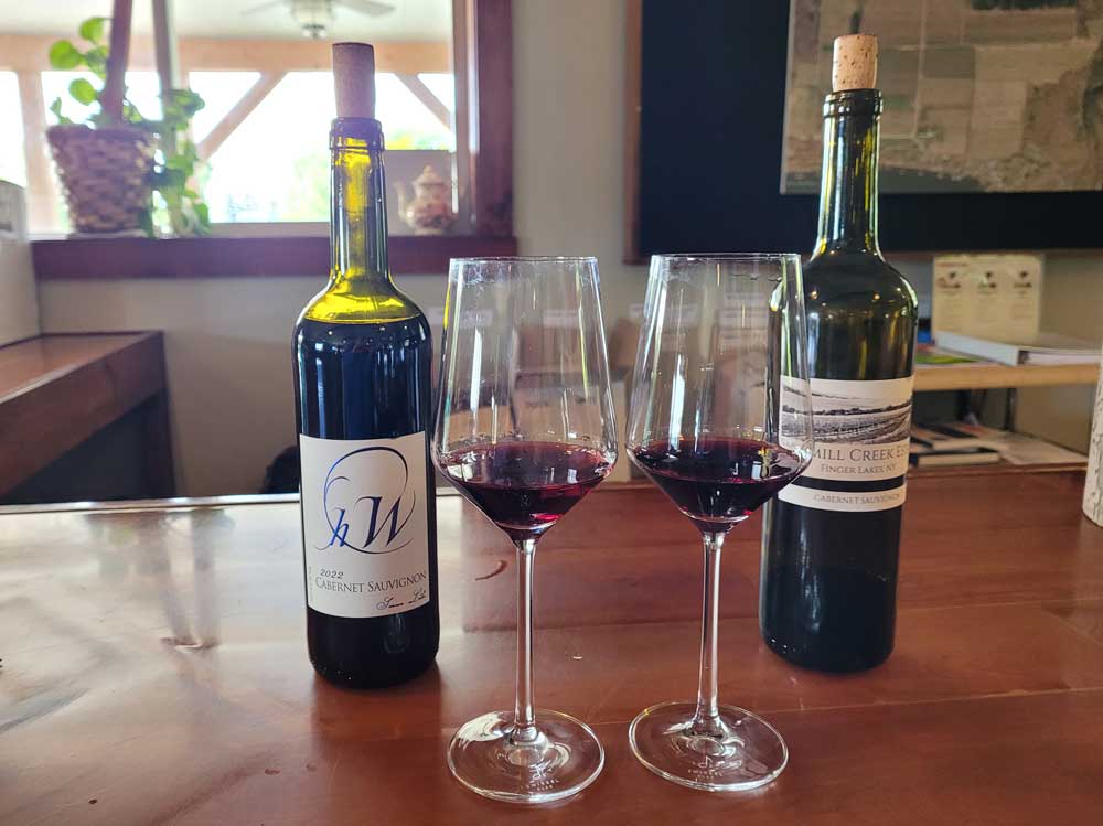 Bottles and glasses of wine for a tasting at Sawmill Creek Winery