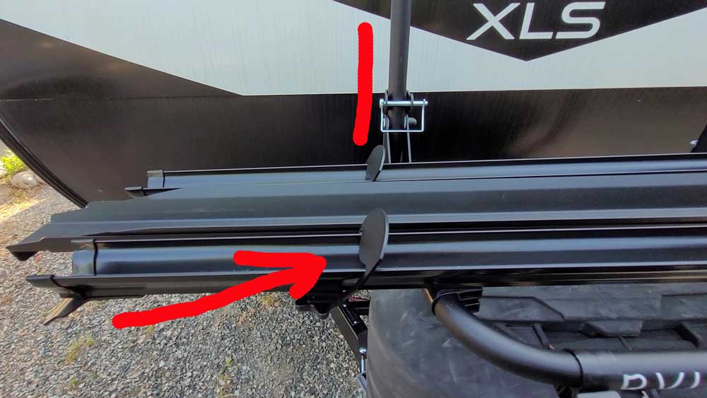 Wheel stops highlighted on travel trailer bike rack